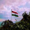 The Indian national flag standing tall against a vibrant sky in Mumbai.