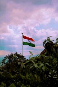 The Indian national flag standing tall against a vibrant sky in Mumbai.